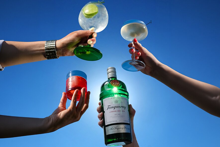 A bottle of Tanqueray Gin with cocktails.