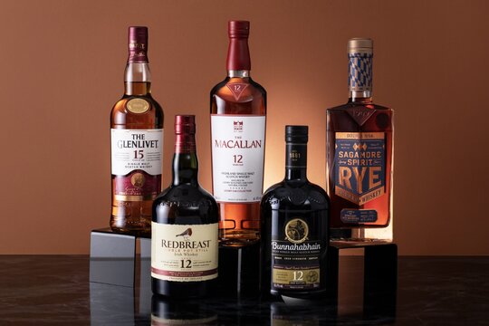 Five bottles of whisky - The Macallan, Redbreast, The Glenlivet, Sagamore, and Bunnahabhain 