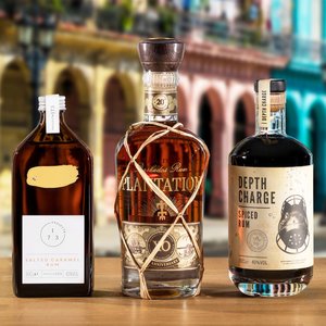 Three bottles of Rum on a city street background.