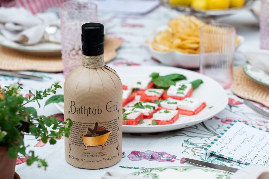 A bottle of Bathtub Gin with menu cards next to it. 