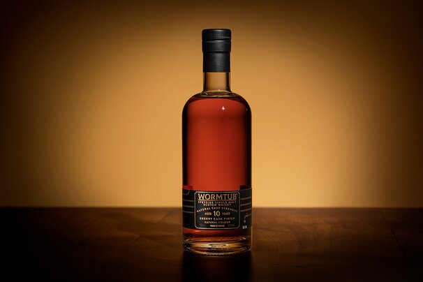 Whisky being poured into a glencairn