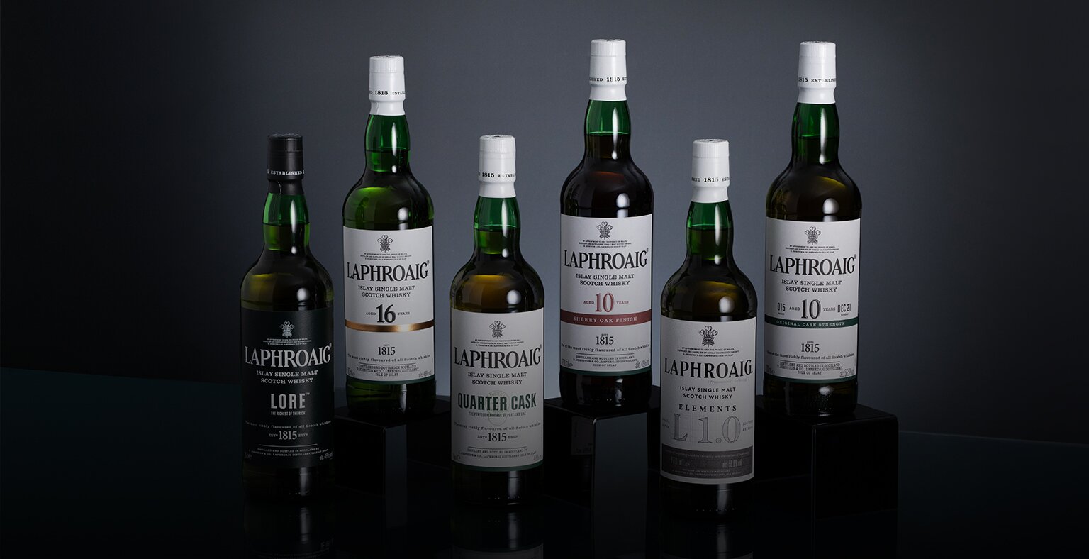 A selection of six bottles from the Laphroaig Whisky range.