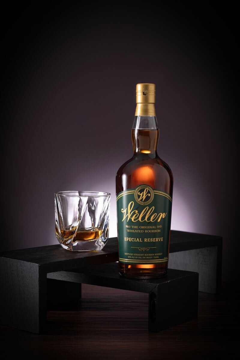 William Larue Weller Special Reserve whiskey bottle and cut glass tumbler