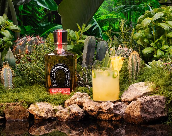 A bottle of Herradura Reposade Tequila and Pina Picante Margarita cocktail. 