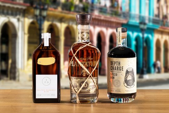 Bottles of Project #173, Plantation & Depth charge rum on a city background.