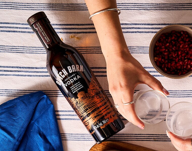 A bottle of Dutch Barn Orchard Vodka on a dinner table