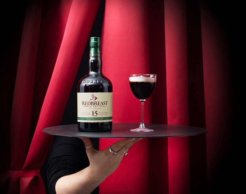 A bottle of Redbreast 15 Year Old and an Irish coffee cocktail.
