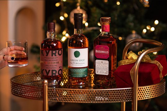 Three bottles of Scotch whisky in a Christmas setting