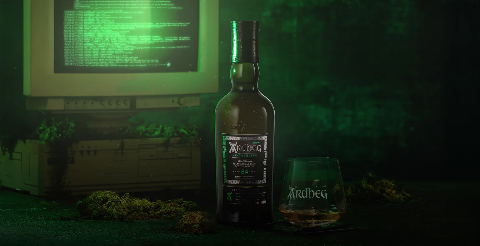 A bottle of Ardbeg Y2k 2024 against a glowing green background.