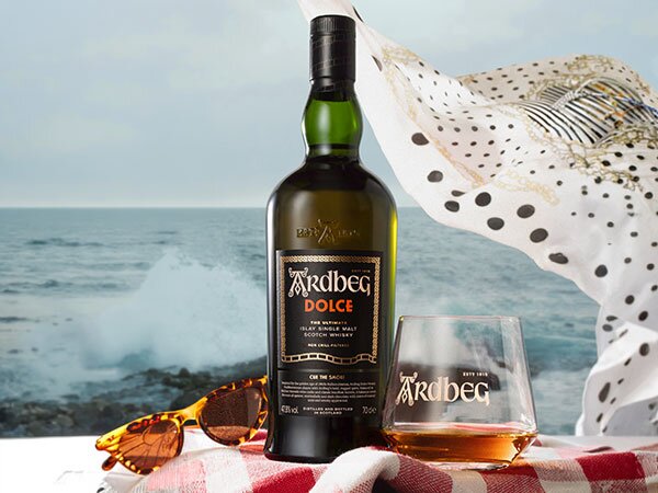 A bottle of Ardbeg Dolce with a branded Ardbeg glass.
