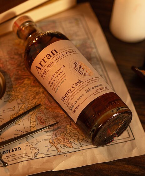 A bottle of Arran Bodega Sherry on top of a map of Scotland. 