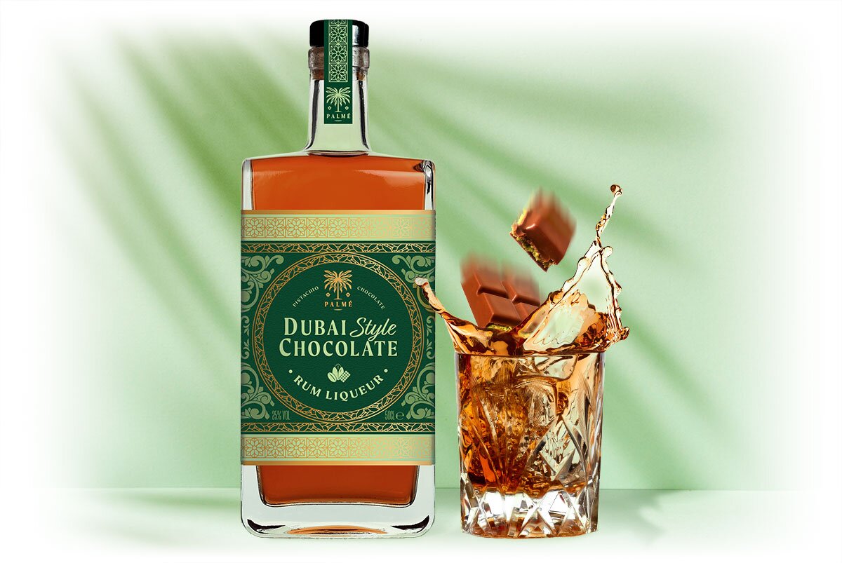 A bottle of Dubai Style Chocolate Rum Liqueur, next to a filled glass