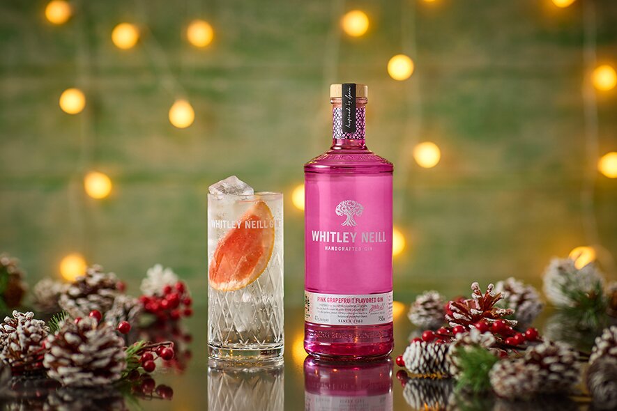 A bottle of Whitley Neill Pink Grapefruit Gin with a G&T.