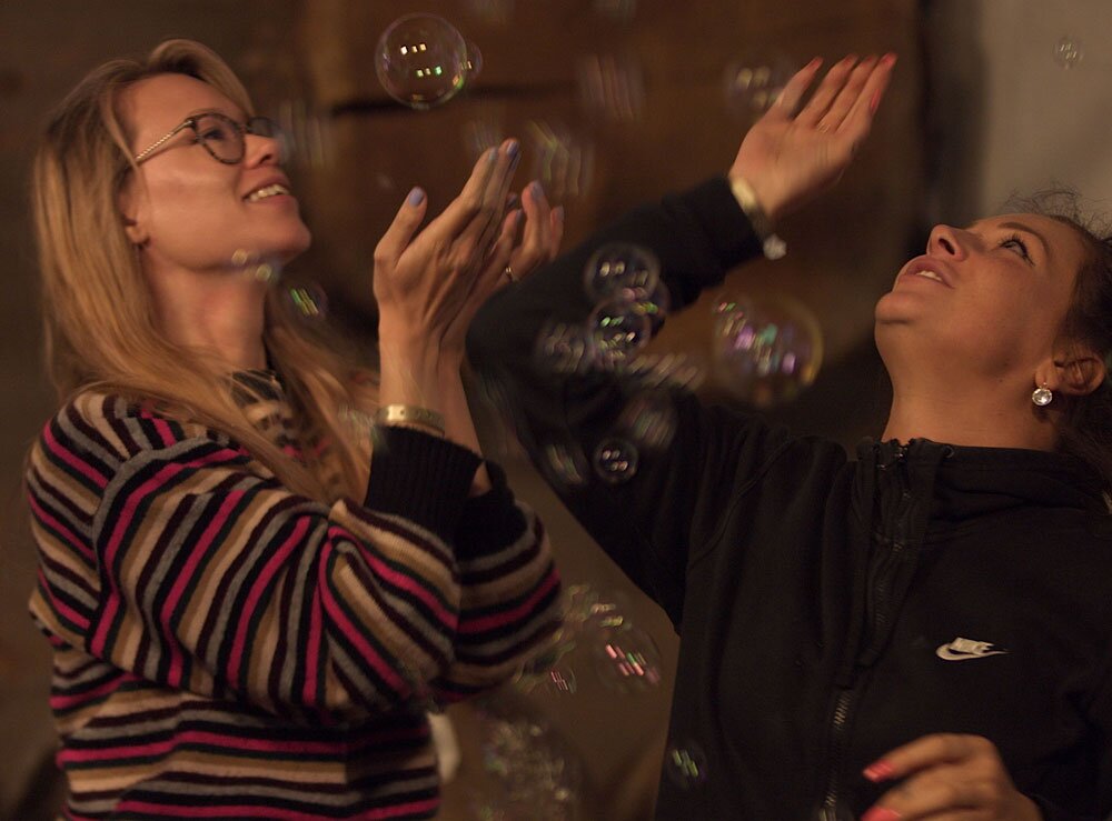 Kristy & Laura playing with whisky-scented bubbles