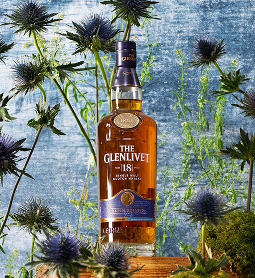 A bottle of The Glenlivet 18 Year Old surrounded by thistles.