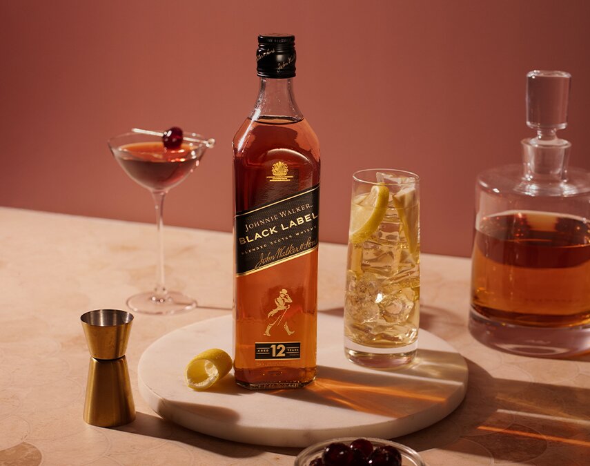 A bottle of Johnnie Walker Black Label with a Johnnie & Ginger.