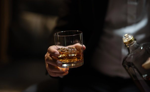 A glass of whisky with ice. 