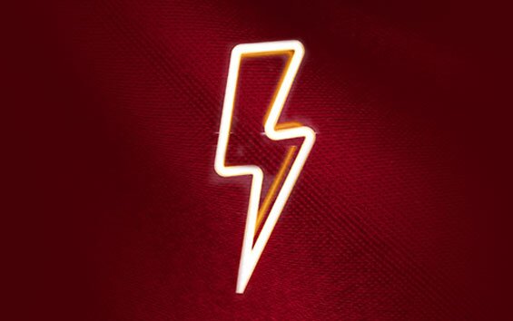 A lightening bolt LED sign on a red background.