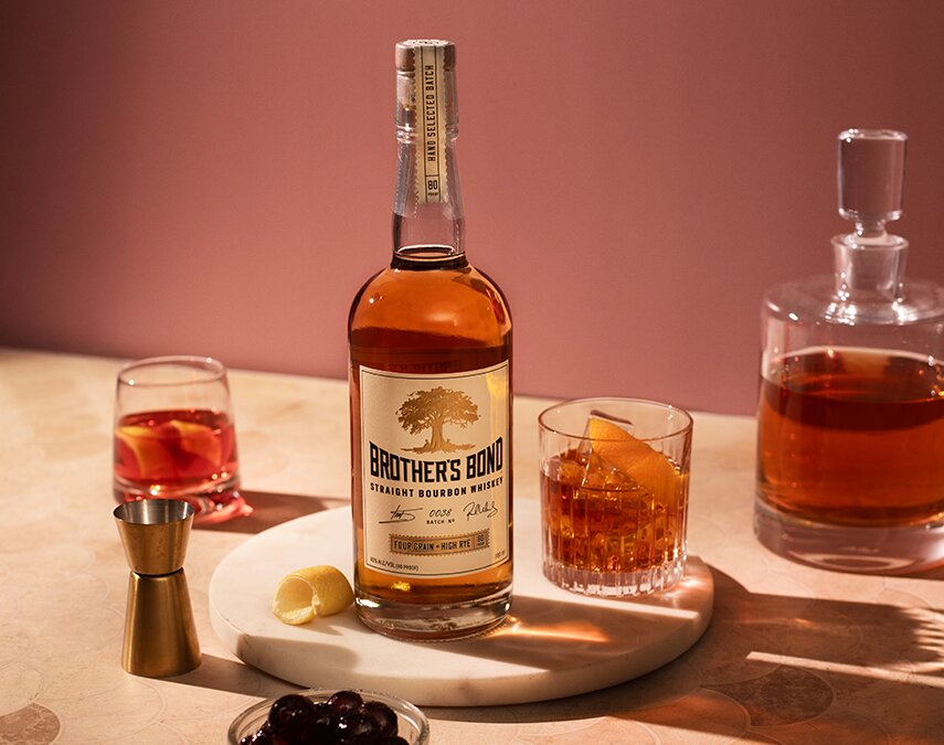 A bottle of Brother's Bond Straight Bourbon and a Boulevardier cocktail.