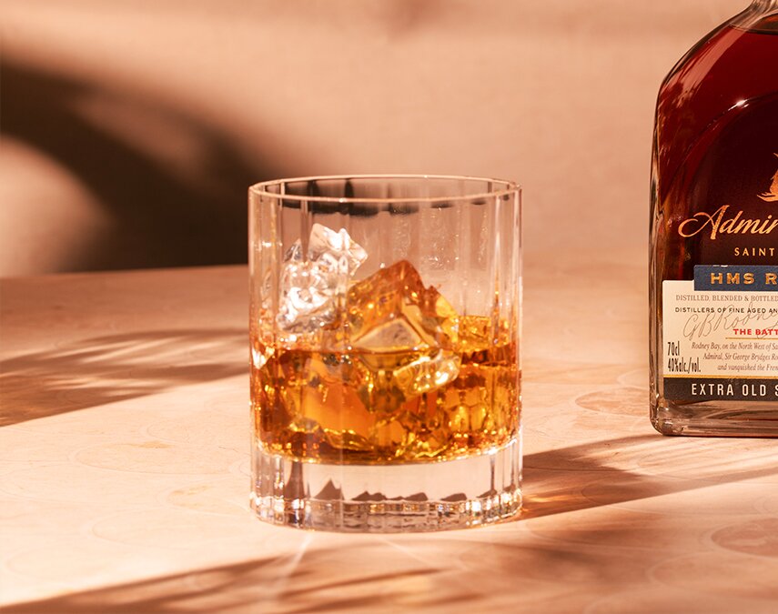 A bottle of Admiral Rodney Royal Oak with a glass of rum.