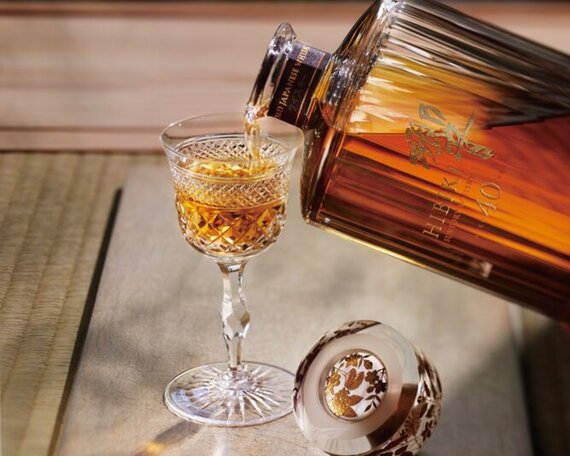 A bottle of the Glenlivet 55 Year Old next to its presentation stand.