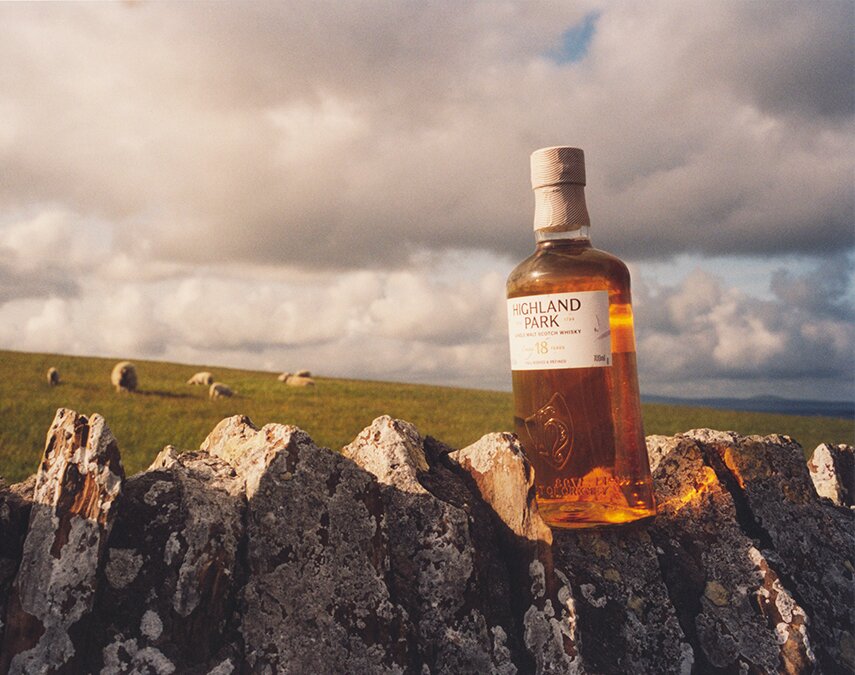 A bottle of Highland Park 18 on a stone wall.