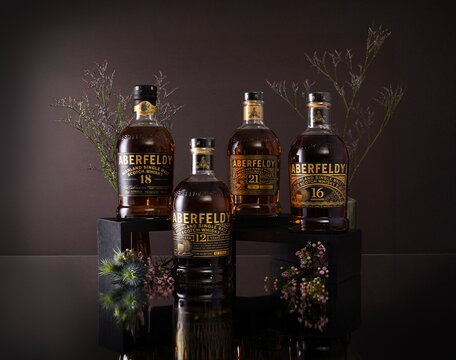 Aberfeldy whisky bottles surrounded by thistles