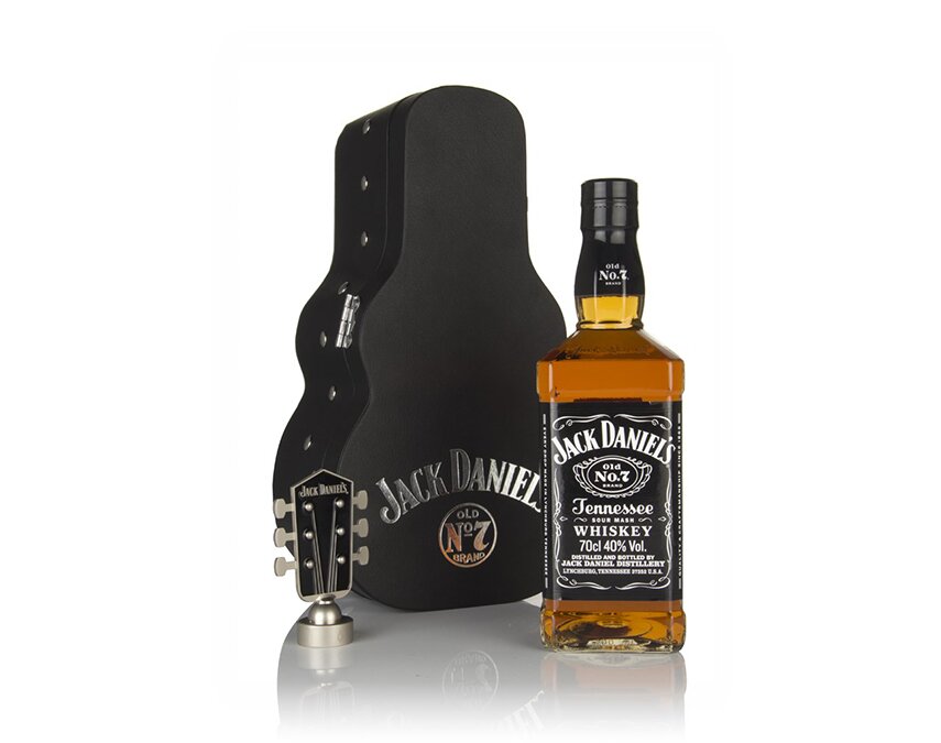A bottle of Jack Daniels and guitar case.
