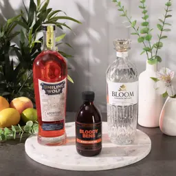 three bottles arranged on a marble plinth