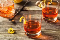 A Sazerac brandy cocktail with twisted lemon garnish.