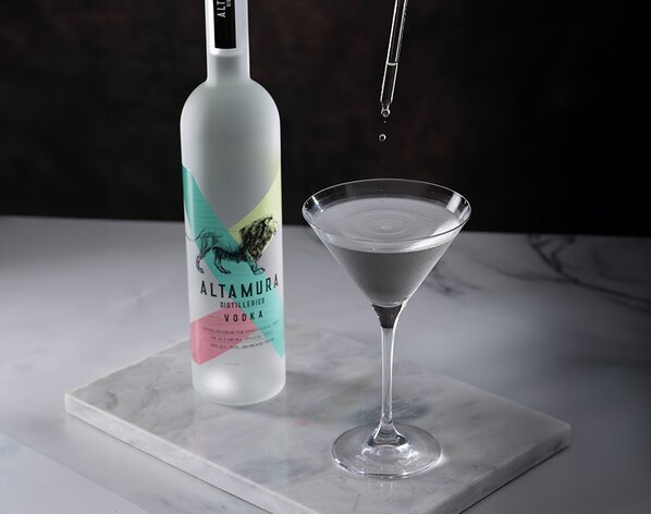 A bottle of Altamura Vodka with a Truffle Martini next to it.
