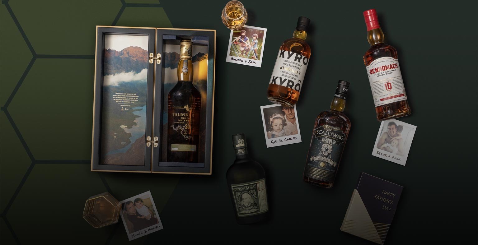 Bottles of spirit laying against a dark green background surrounded of Polaroid pictures of MOM employees and their dads. 