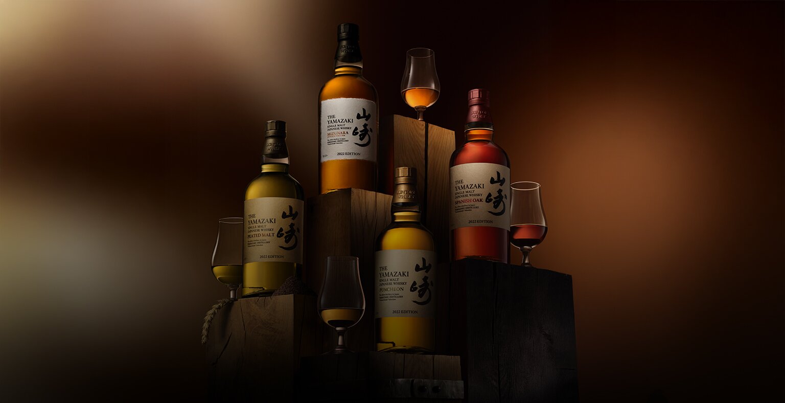 Four bottles of Yamazaki whisky on wooden plinths