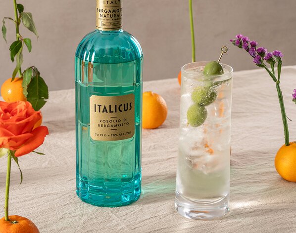 An Italicus Long Negroni Spritz with a bottle of Italicus on the left of it.