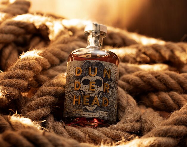 A bottle of Dunderhead rum on ropes.