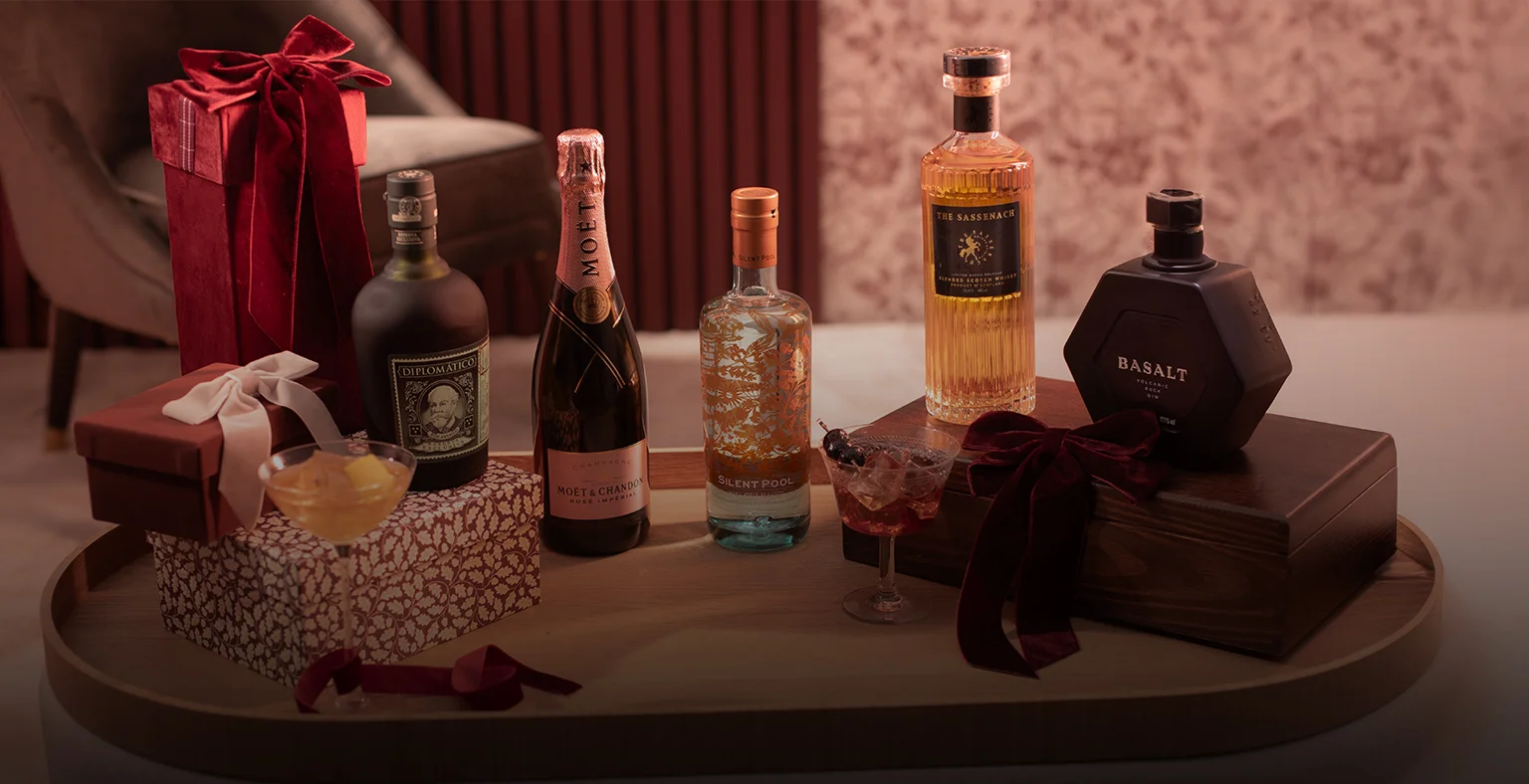 Five bottles of spirit on a Valentines themed table. 