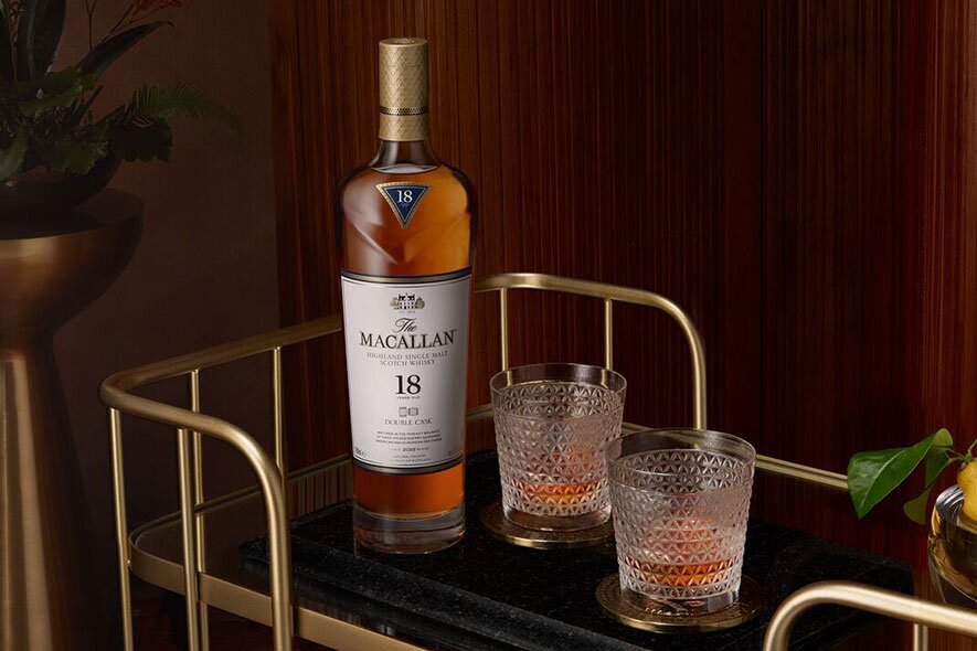 Three bottles of Macallan whisky and 2 glasses. 