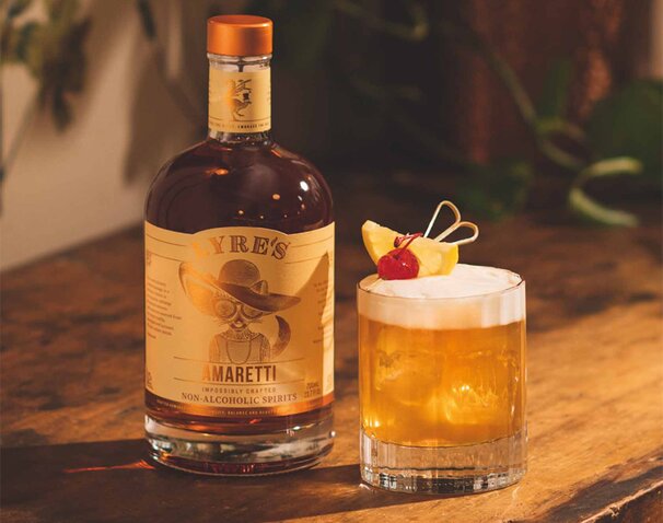A bottle of Lyre's Amaretti and an Amaretti Sour cocktail.