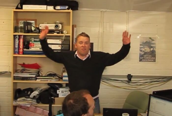 Tom pulling silly face in early office