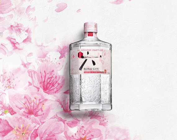 A bottle of Roku Sakura Bloom against a watercolour cherry blossom background.