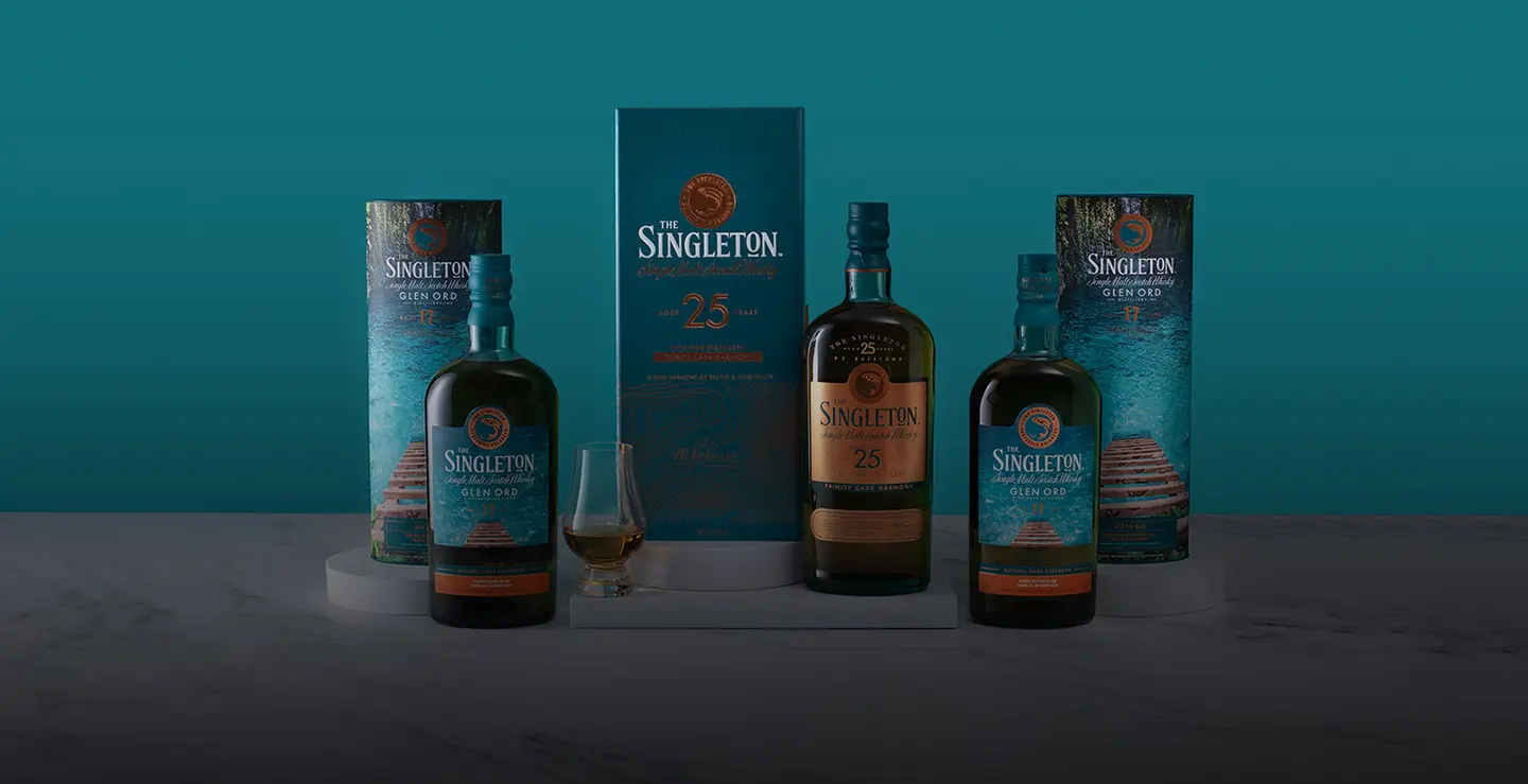3 bottles of Singleton Whisky on a blue background.