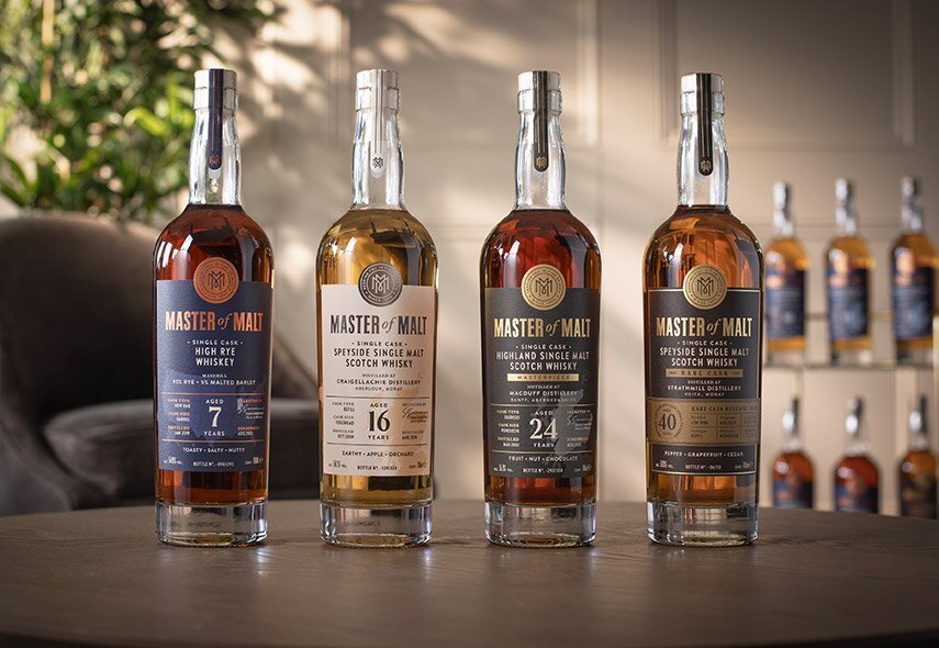 4 bottles of whisky on a table.