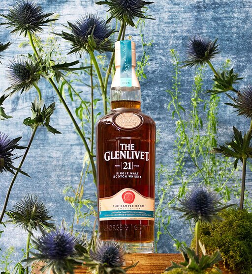 A bottle of The Glenlivet 21 Year Old - The Sample Room Collection surrounded by thistles.