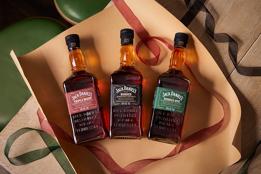 Three bottles of Jack Daniel's whisky on wrapping paper. 
