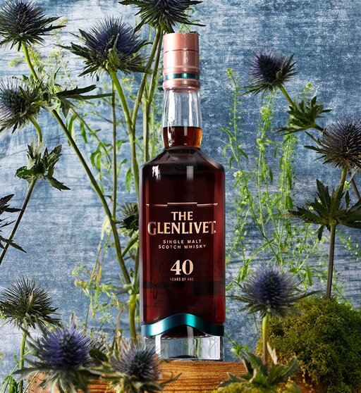 A bottle of The Glenlivet 40 Year Old surrounded by thistles. 