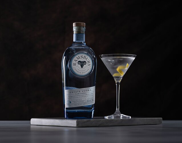 A bottle of Ramsbury Vodka with a Vodka Martini on the right of it.