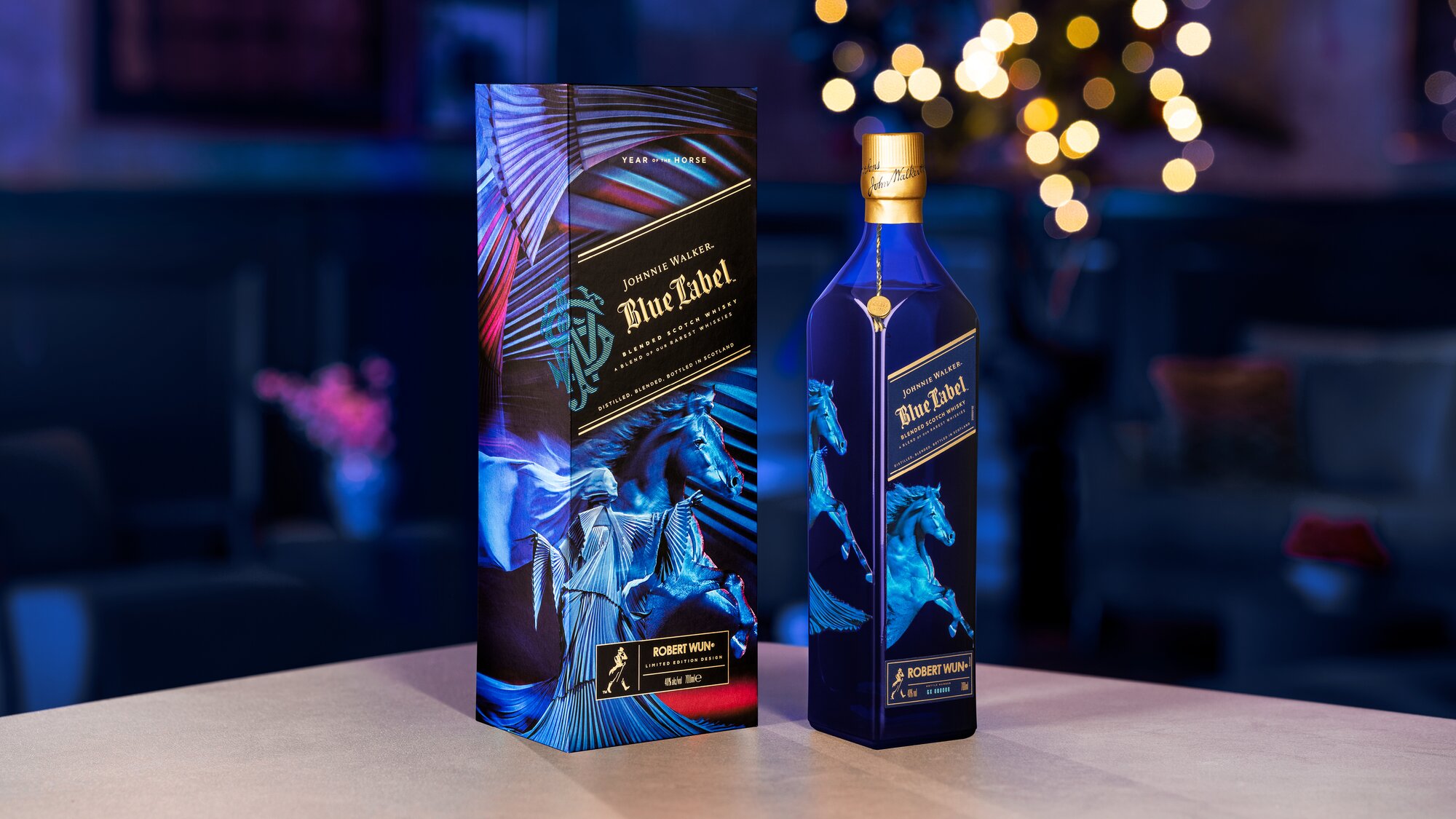 A bottle of Johnnie Walker Year of the Horse on a table with blue background.