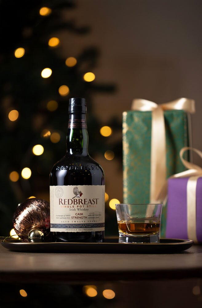 Redbreast 12 Year Old Cask Strength whiskey bottle with Christmas background