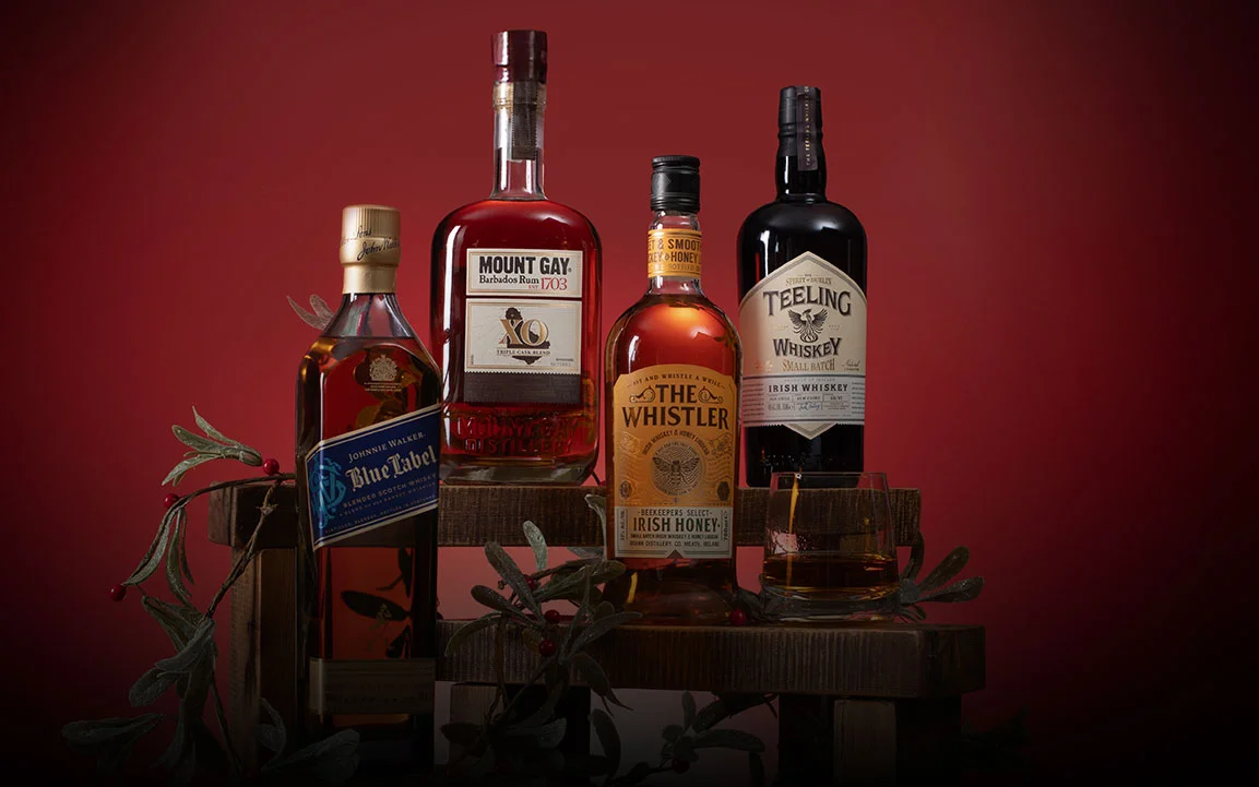 A range of bottles on a green Christmas background