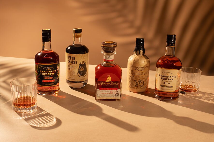 5 bottles of rum on a beige background.